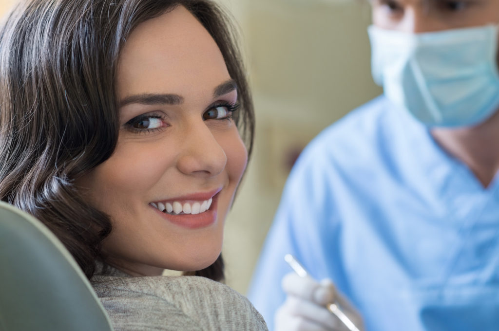 woman on dentist chair smiling