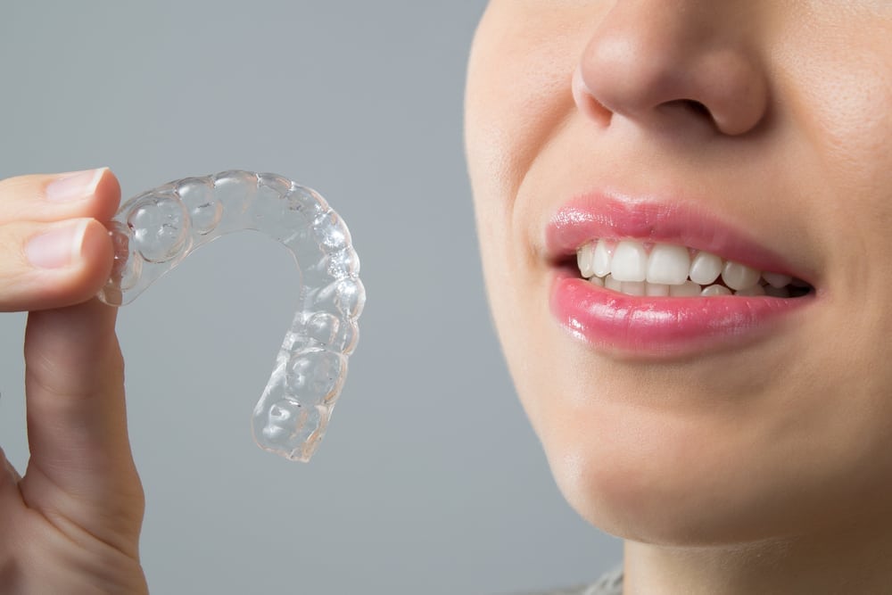 woman holding an invisalign