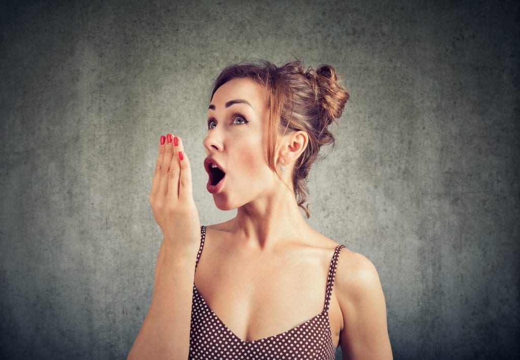 woman smelling her breath