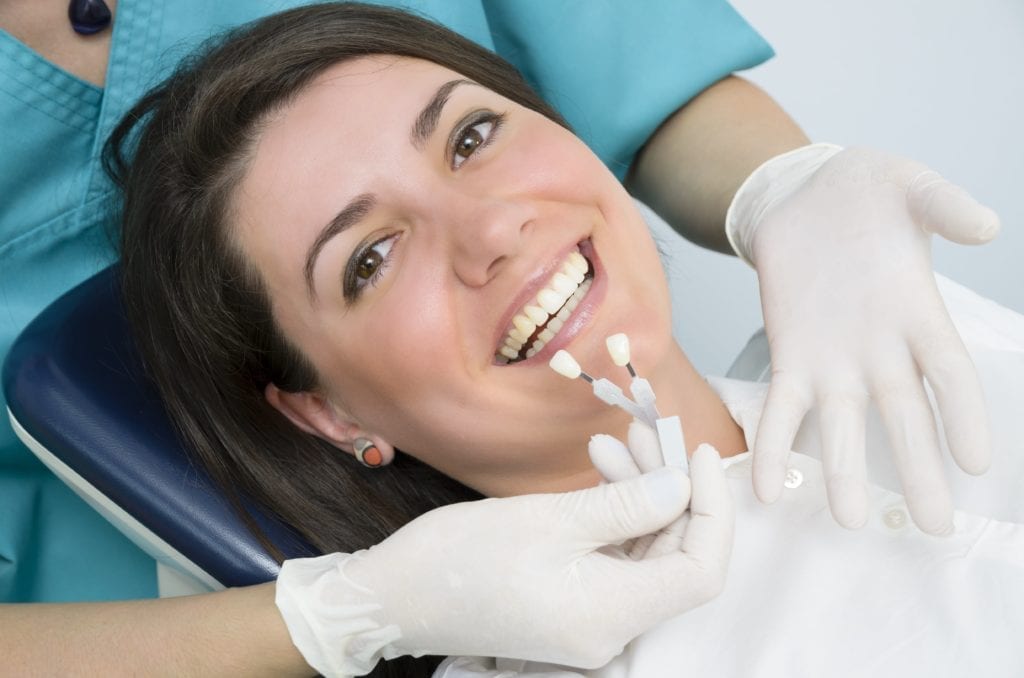 woman being color matched for teeth whitening