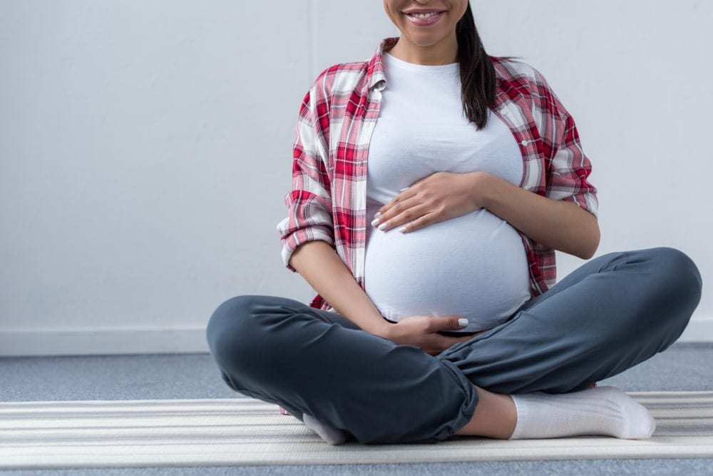 pregnant woman sitting on the floor
