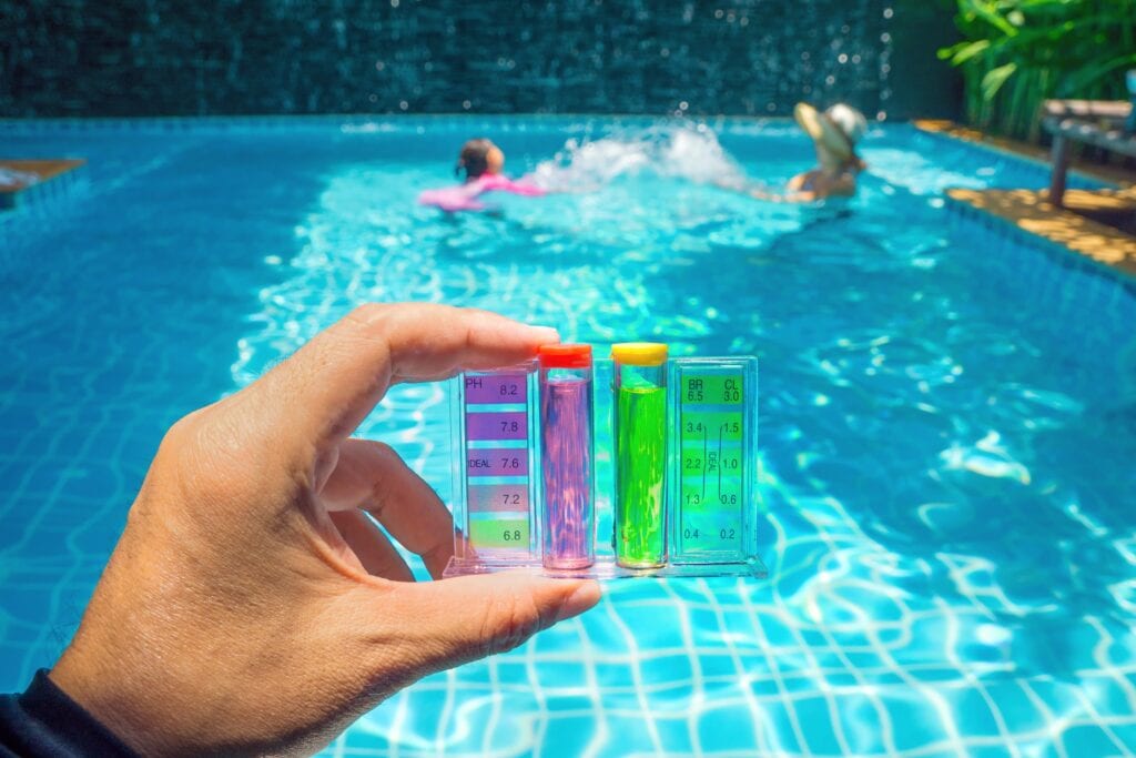 man testing chlorine concentration in pool