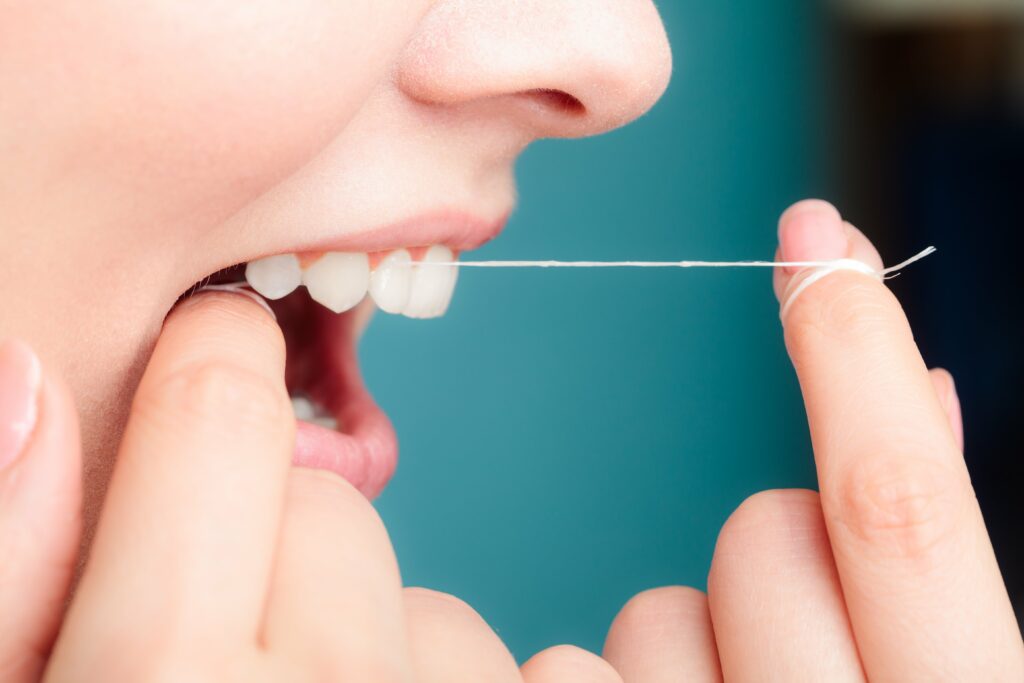 woman flossing teeth